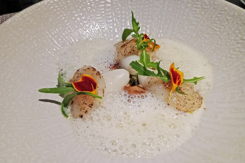 A delectable Hokkaido Scallop dish, expertly crafted by Koral Restaurant at The Apurva Kempinski Bali.